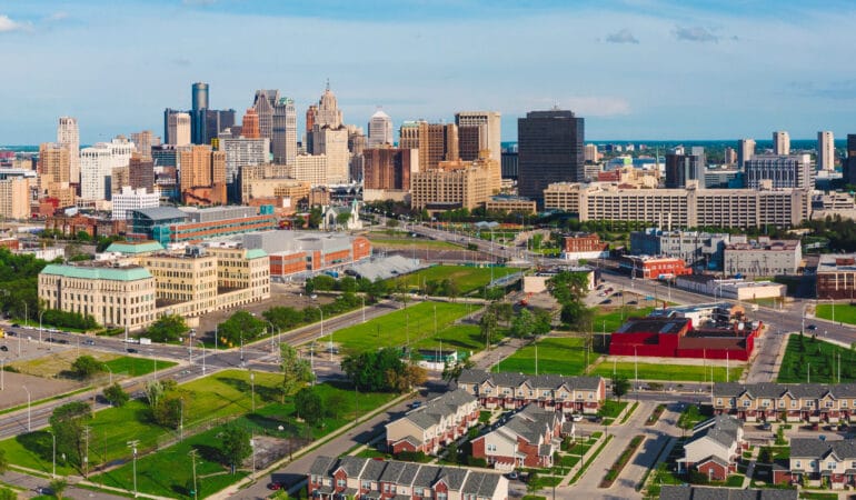 Image of downtown Detroit with a residential neighborhood in the foreground.