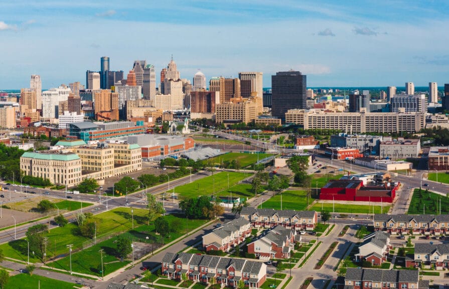 Image of downtown Detroit with a residential neighborhood in the foreground.