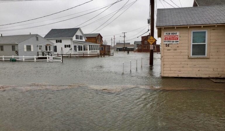 At least a foot of water floods a neighborhood of single family houses
