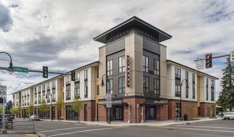 A mixed-used development sits at an intersection in Oregon. The first floor is a library. The other floors are affordable senior housing.