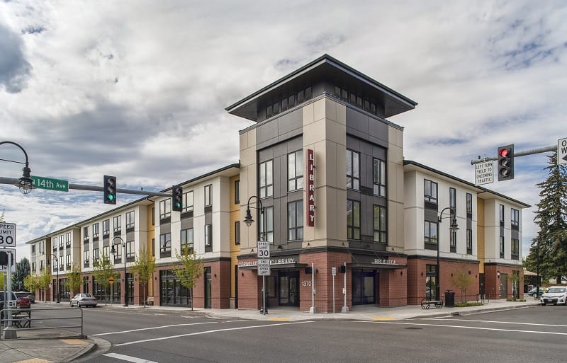A mixed-used development sits at an intersection in Oregon. The first floor is a library. The other floors are affordable senior housing.