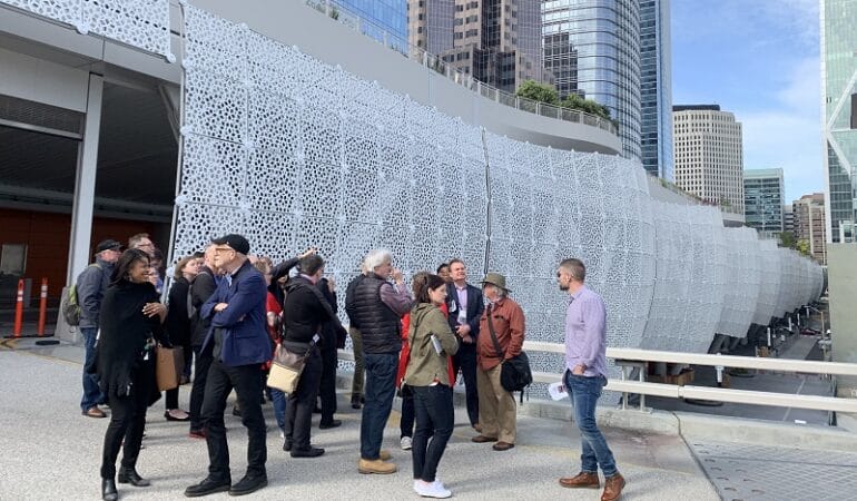 A group of city planners stands outside of the Transbay Transit Center in San Francisco.