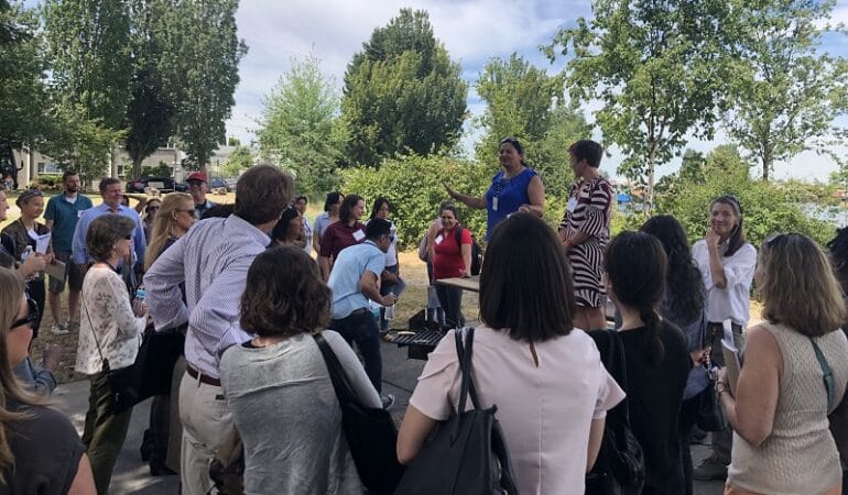 Paulina Lopez speaks to attendees of the Grantmakers in Health Conference in June as part of a tour of the South Park neighborhood.