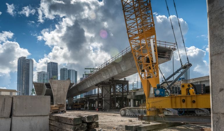 Construction of a bridge in downtown Miami. Credit: CHUYN via istock/Getty Images Plus.