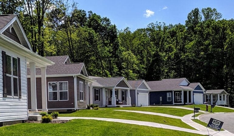 A row of manufactured homes with tidy lawns