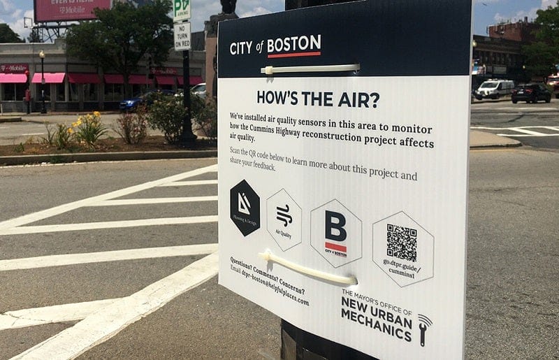 A sign in Boston invites residents to engage with air quality monitoring technology.
