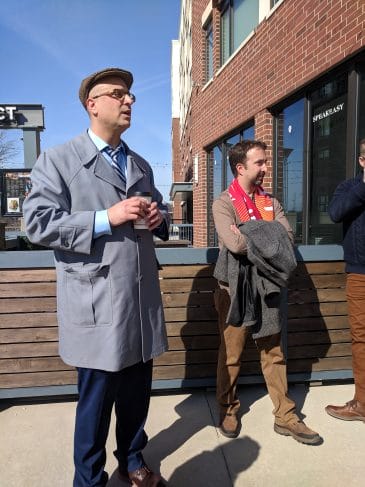 Jason Segedy, director of planning and urban development at the City of Akron, speaks to community of practice participants outside an Akron building.   